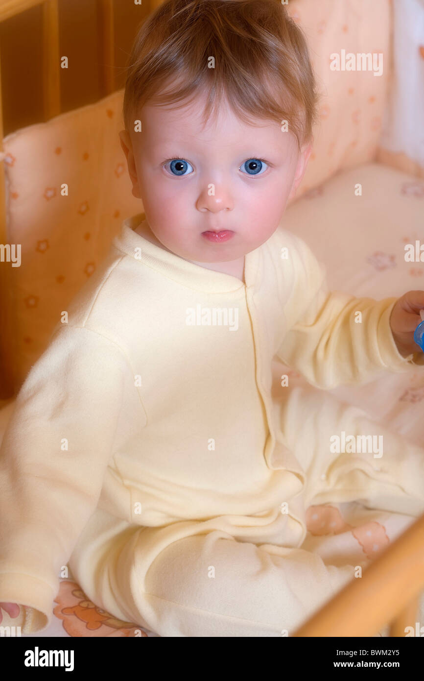 Baby boy 11 Months old toddler portrait child children one person blue eyes blond bed portrait Stock Photo