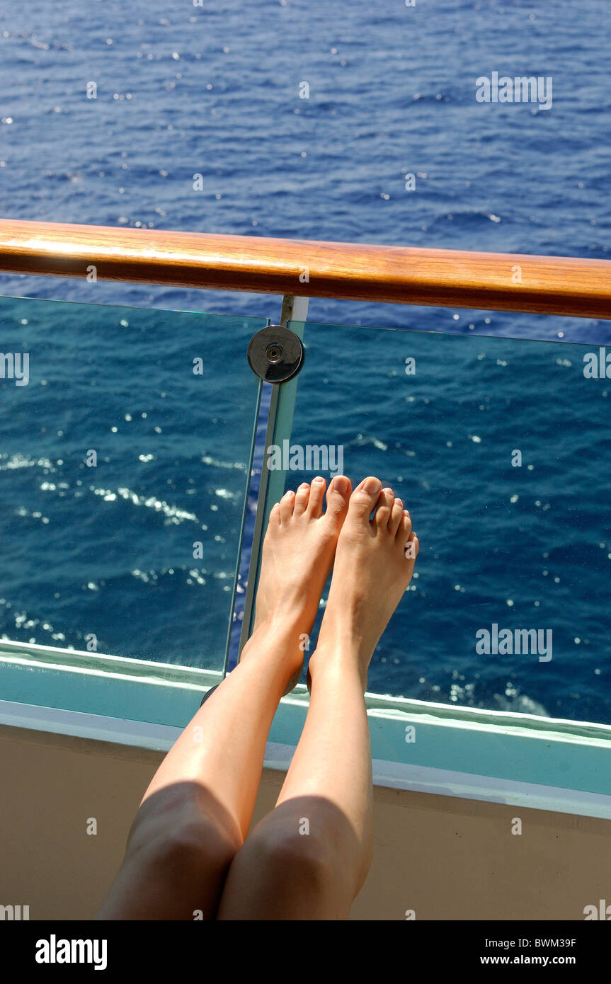 Cruise ship Looking out Railing Ship Cruiser Woman Close-up Detail Feet Barefoot Female Relaxed Sun Bath Stock Photo
