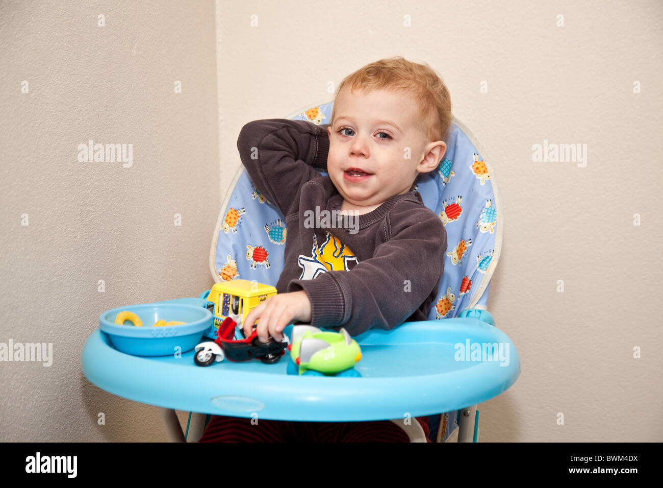 One Year Old Baby Boy Sitting In A High Chair Devon England