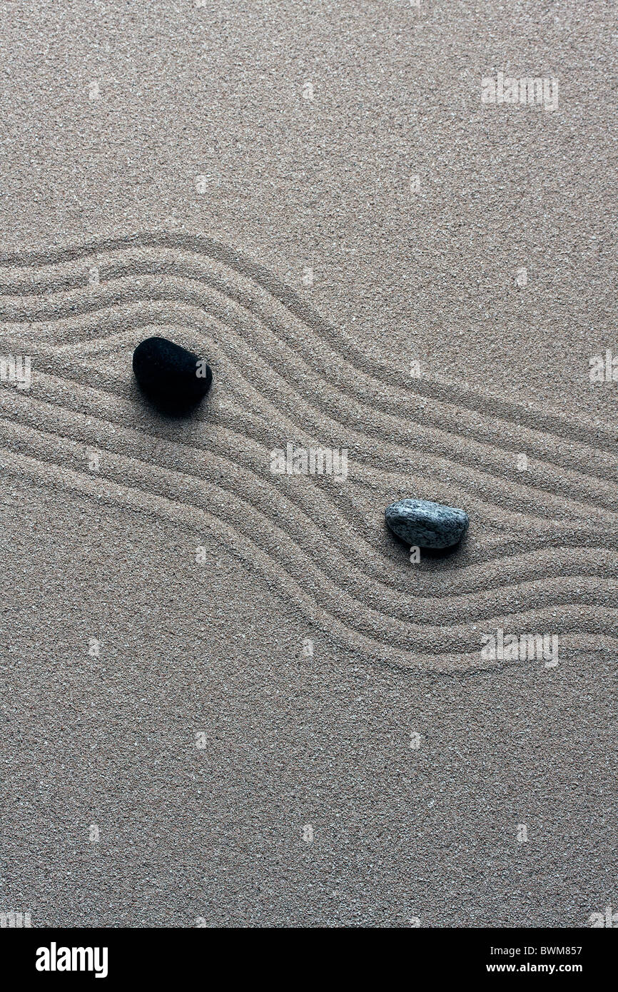 raked sand - zen rock garden - japan zen spirit inspired arrangement Stock Photo