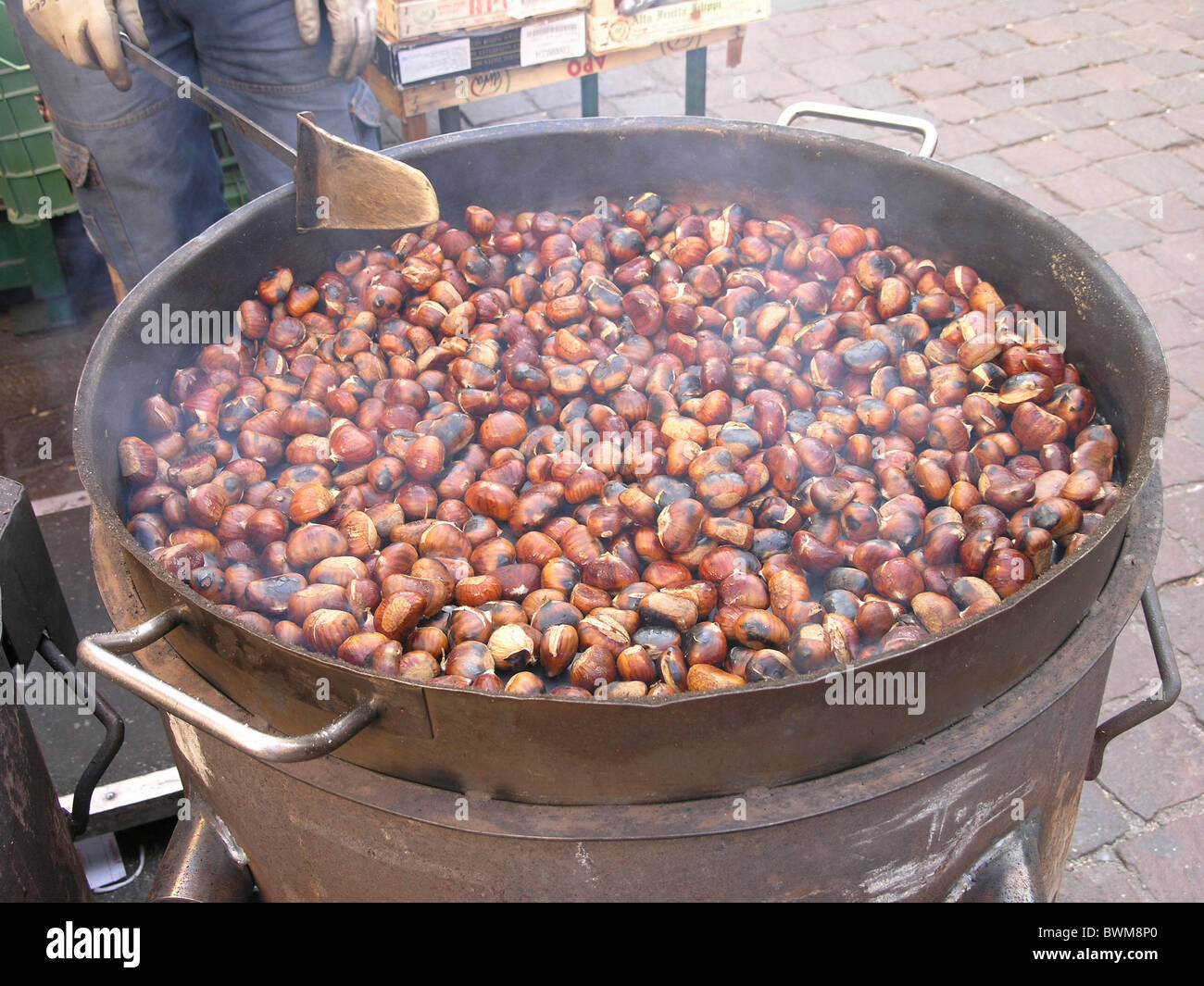 Roasted chestnut in frying pan on black stone background Stock Photo - Alamy