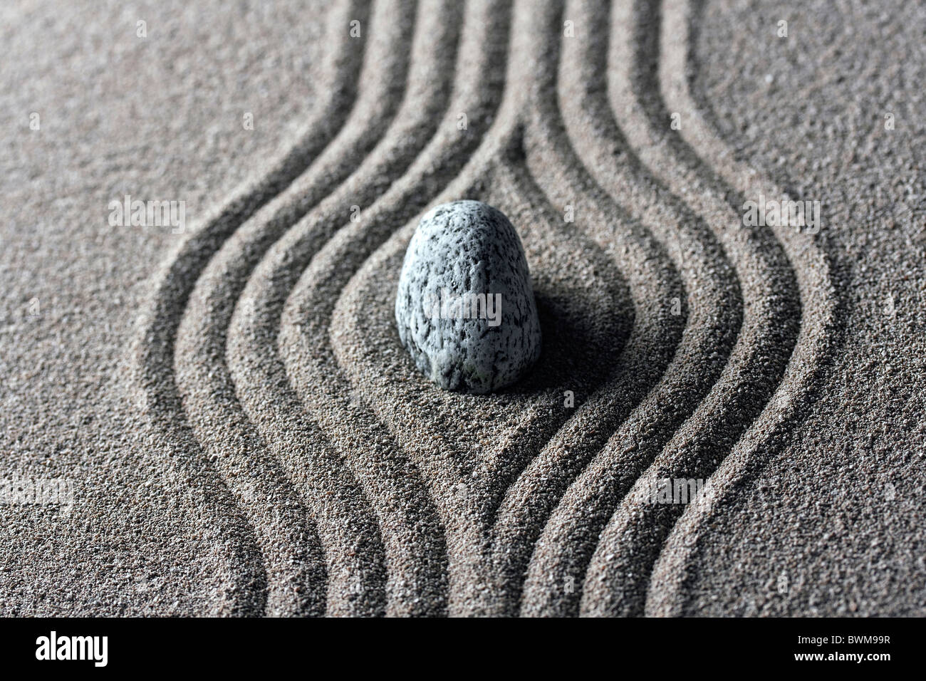 raked sand - zen rock garden - japan zen spirit inspired arrangement Stock Photo