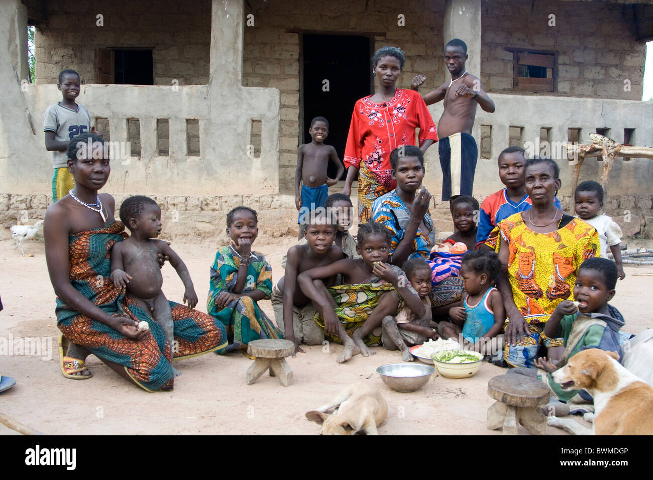 A family eating in front of his hut Central African Republic Stock Photo