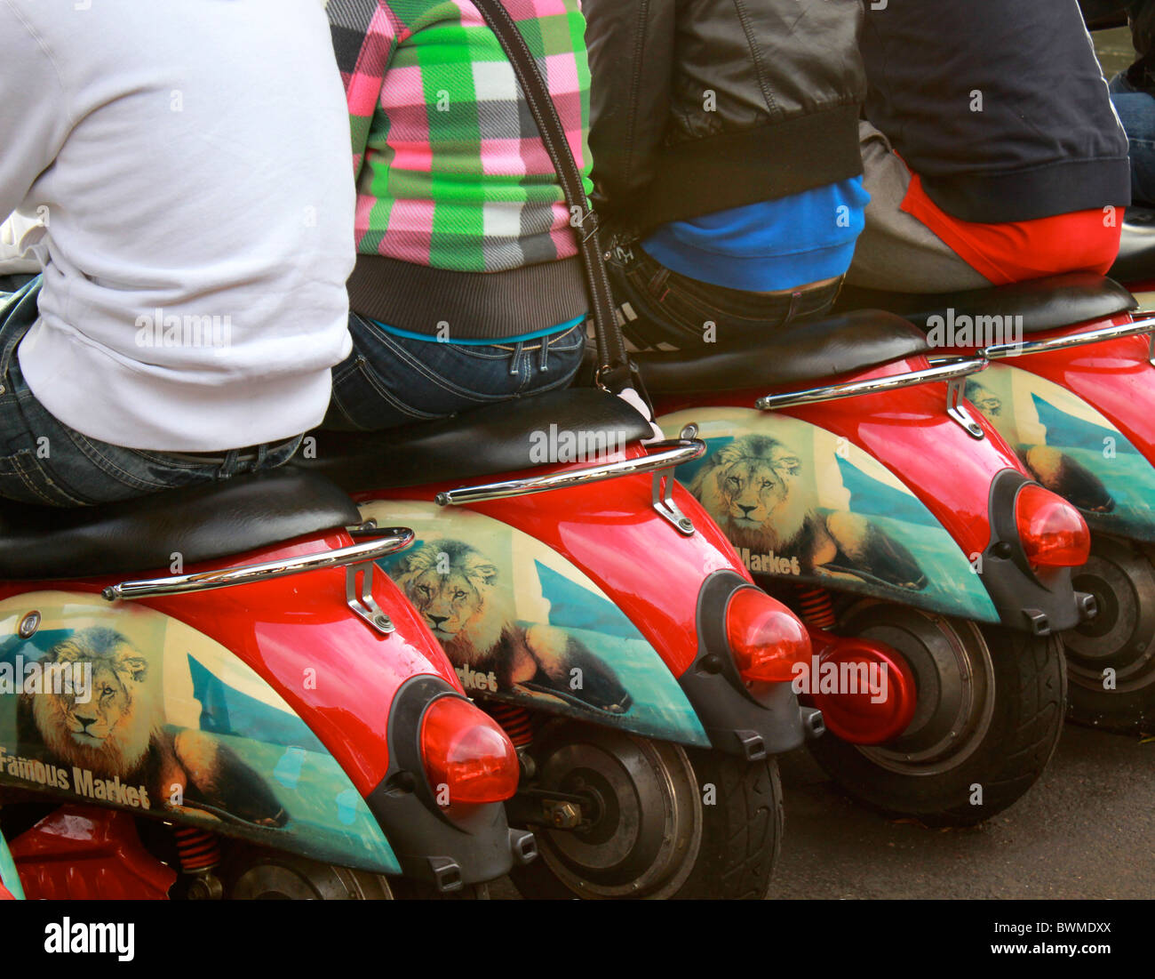 Scooters Rear View The rear view of four people sitting on scooters in a cafe Stock Photo ...