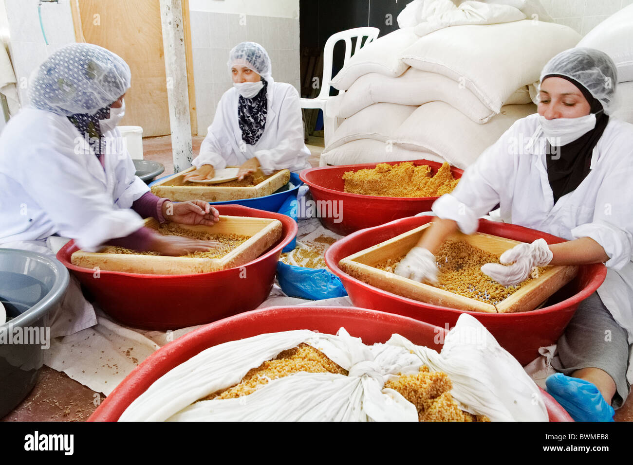 Women working in a couscous factory, at Jericho Stock Photo