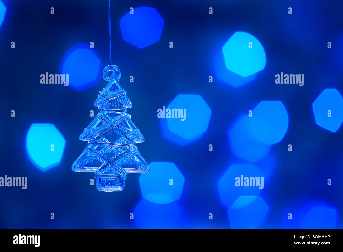 Glass christmas tree. Defocused lights background. aRGB. Stock Photo