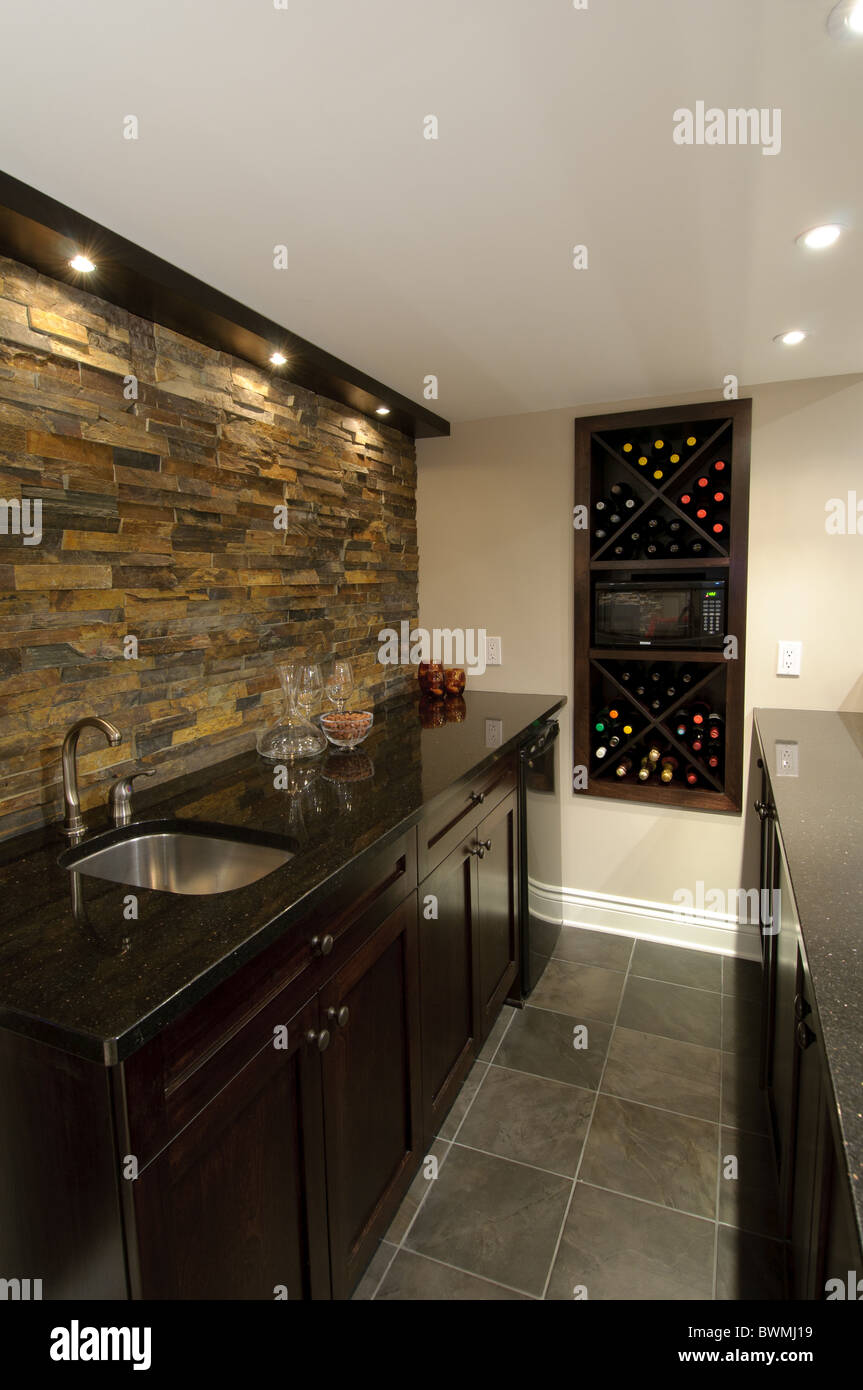 Luxurious residential basement bar stocked with alcohol. Stock Photo