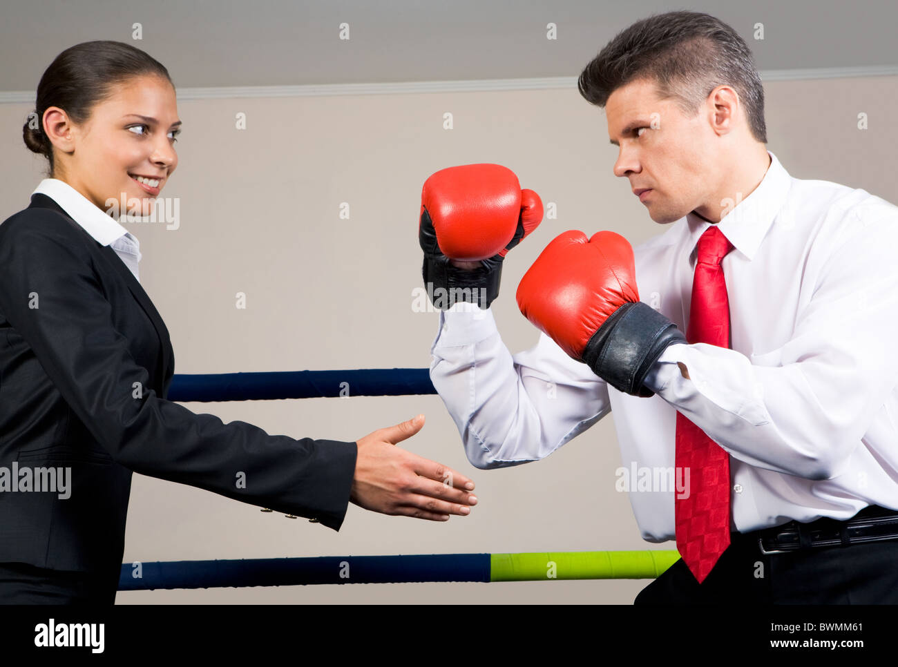 Portrait of aggressive businessman in boxing gloves fighting with
