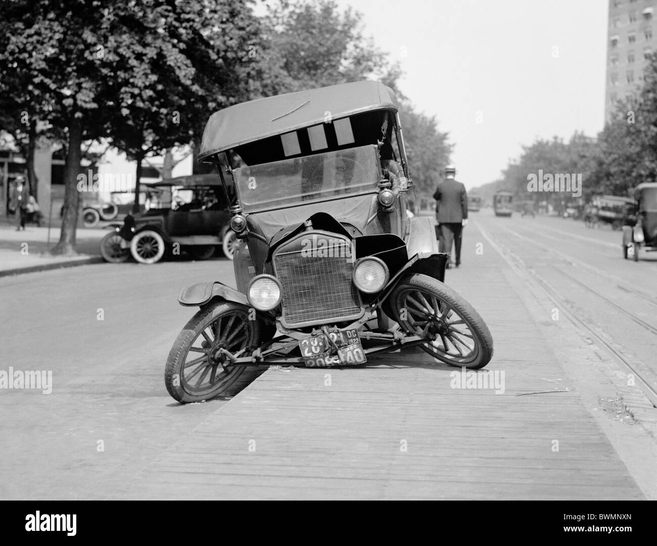 Vintage photo circa 1922 of a Ford motor car wrecked in an automobile accident in the USA. Stock Photo