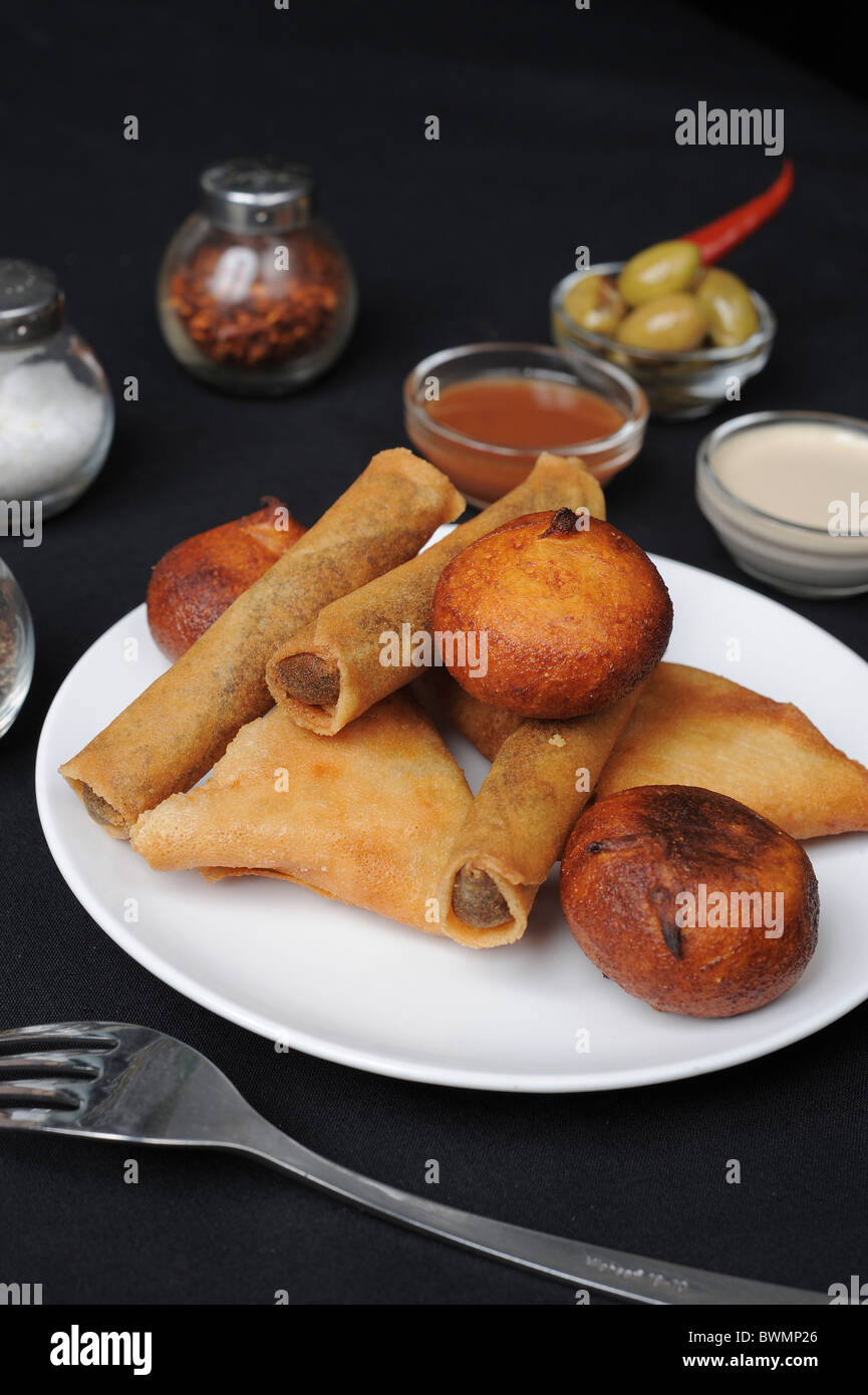 Deep fried savoury pastries filled with meat Originally from Morocco Stock Photo