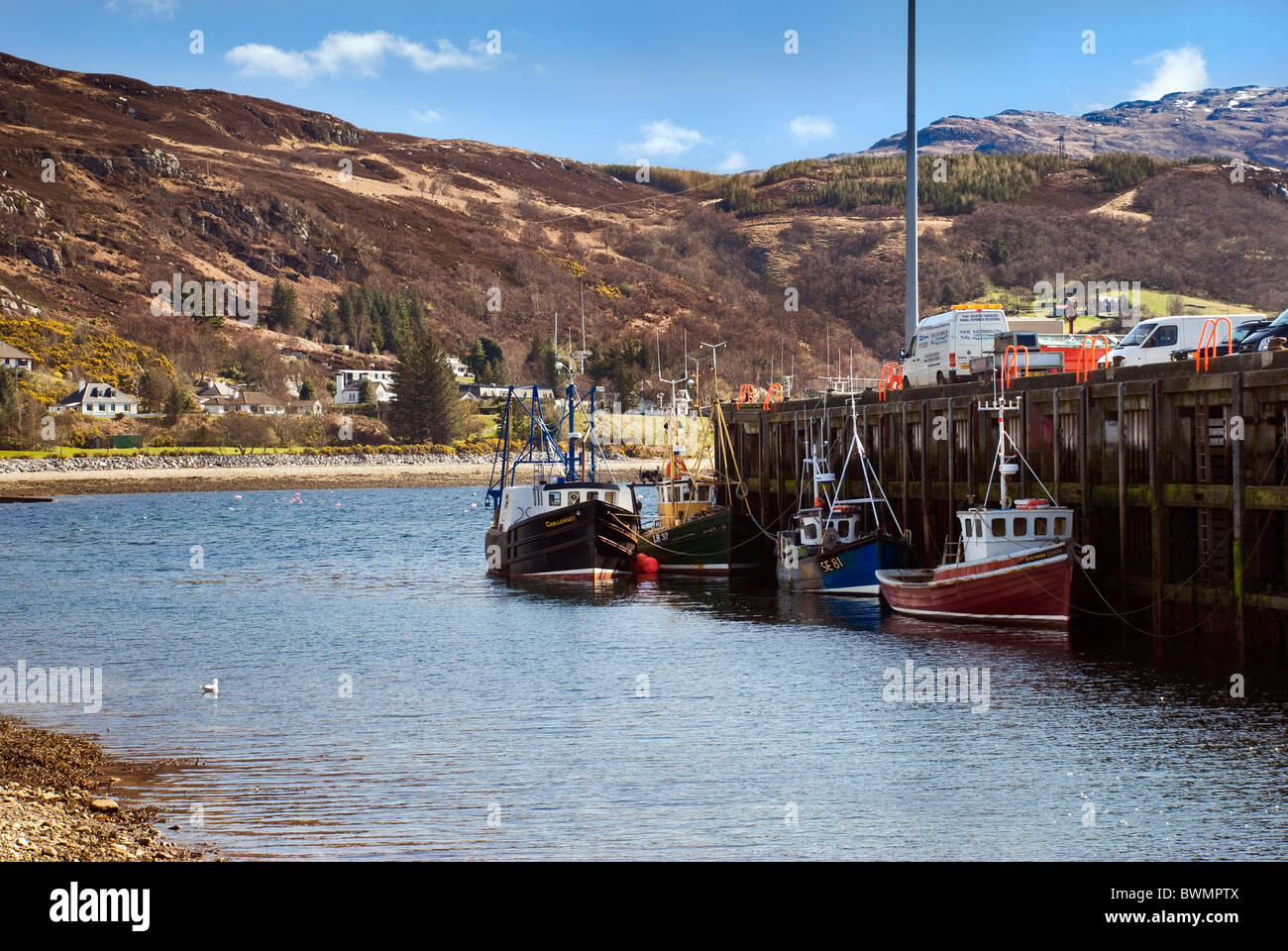 Fishing boats and trawlers at Ullapool harbour on loch Broom on fine sunny day in Spring Stock Photo