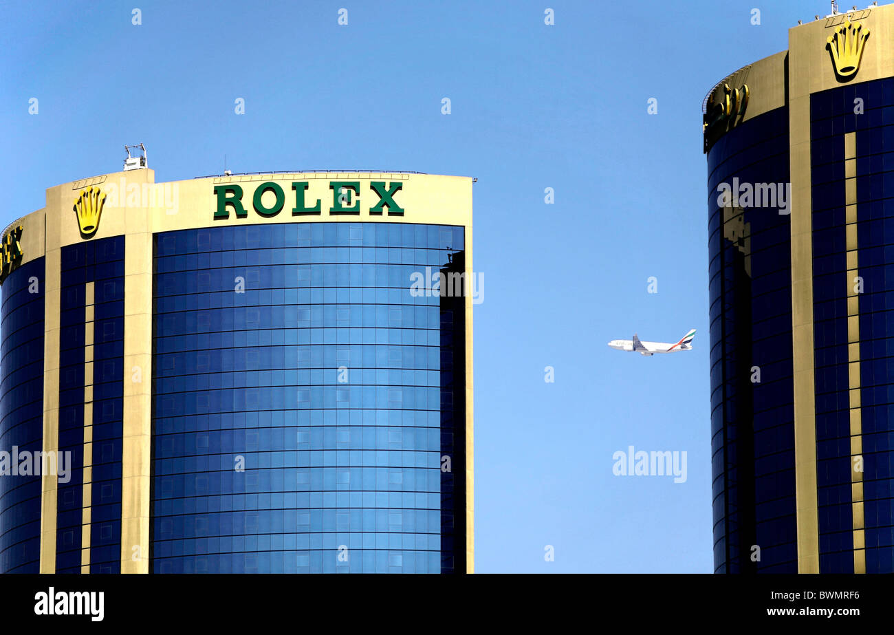 Aircraft Flies Behind the Rolex Twin Tower Complex, United Emirates Dubai,  Middle East Stock Photo