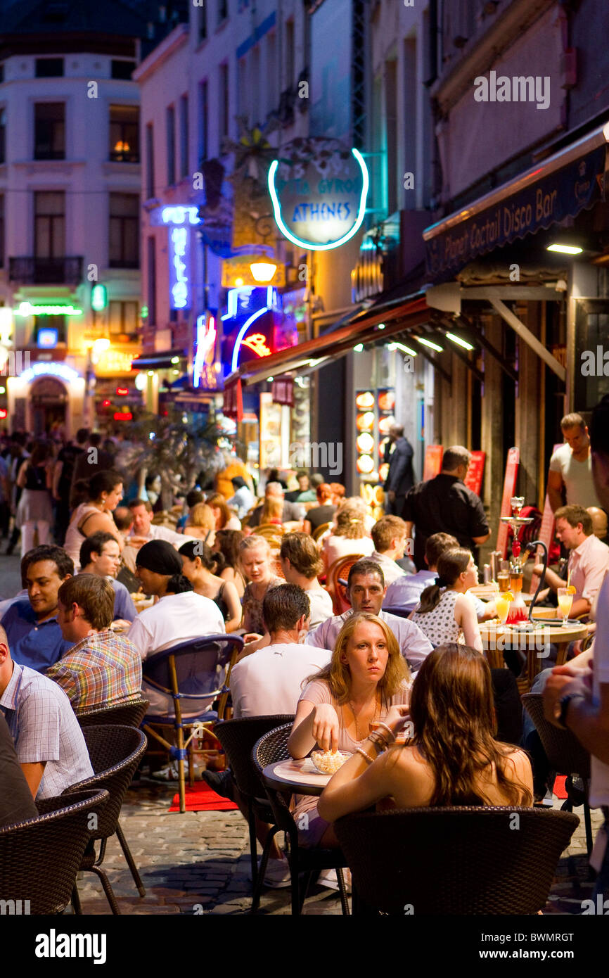 brussels night life group crowd diners evening eat eating drinking dining outside al fresco restaurant cafe time seated young pe Stock Photo