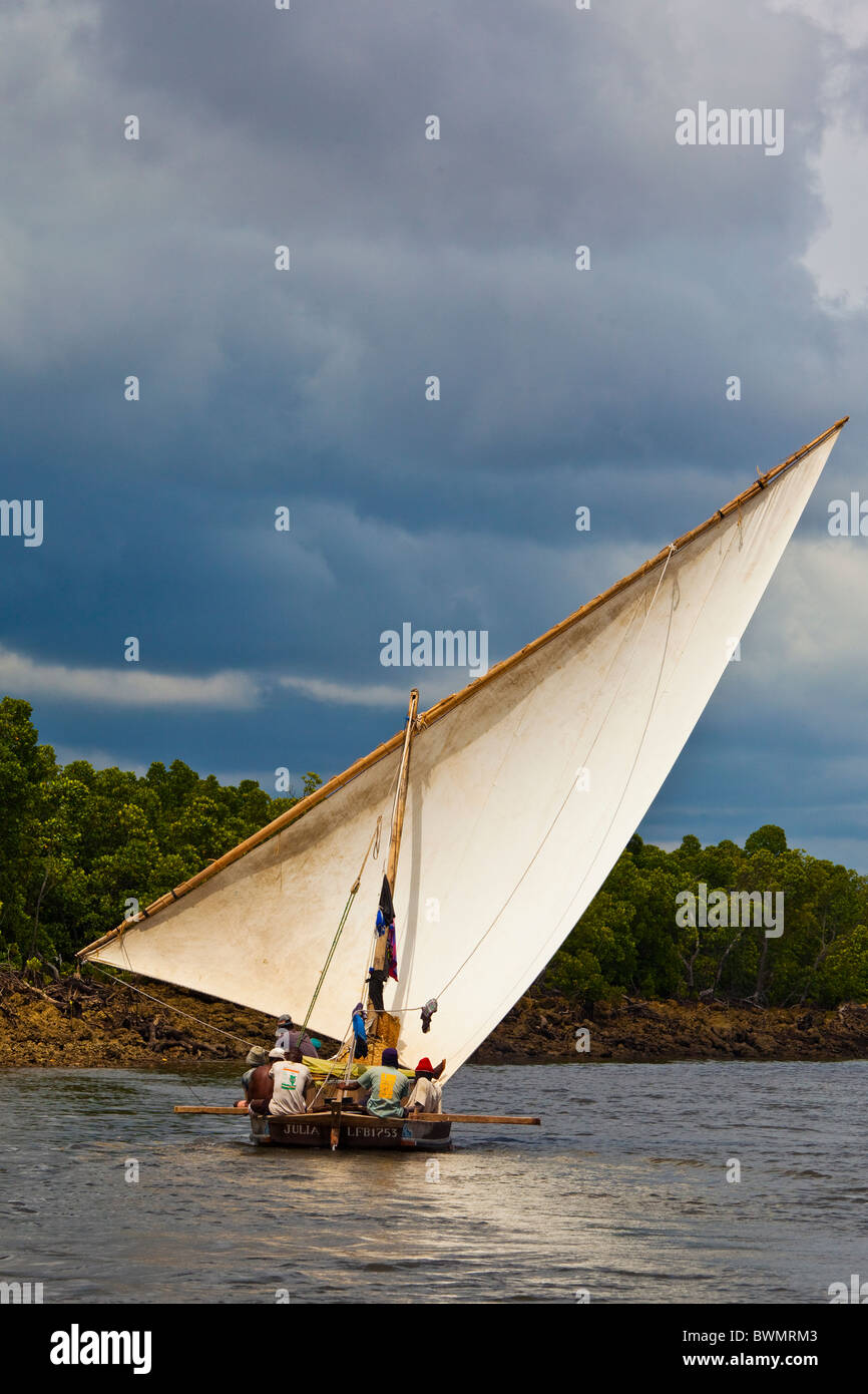 Dhow sailing in a channel off of Lamu Island, Kenya Stock Photo