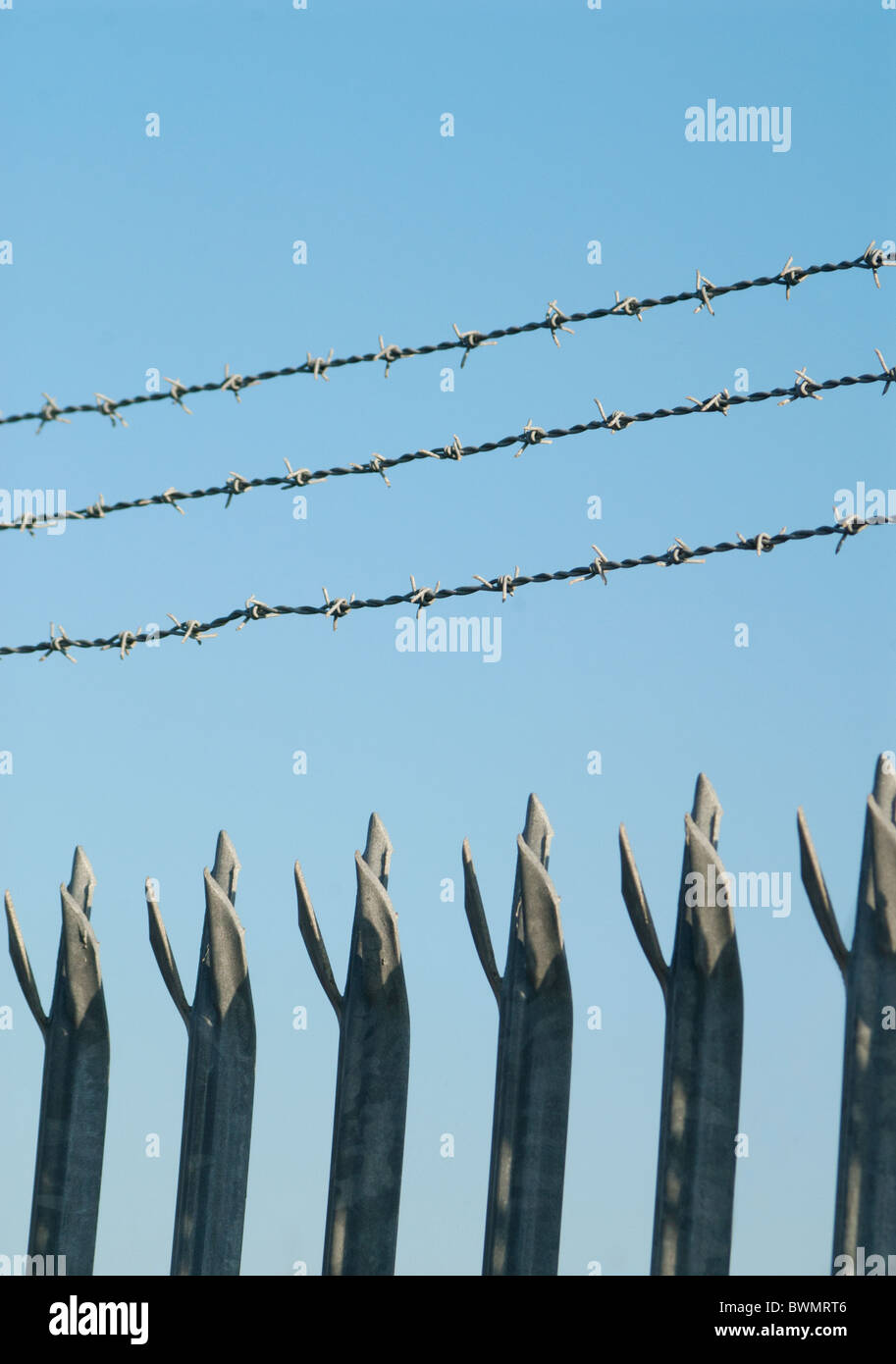 Barbed Wire and Spiked Security Fence Stock Photo