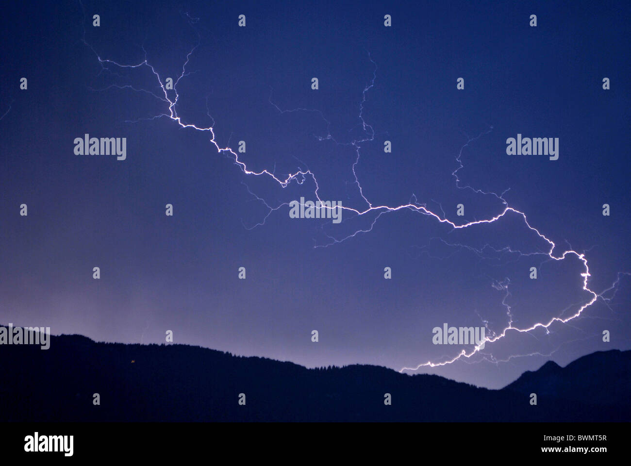 lightning in the night sky background of the Dolomites mountains Stock Photo