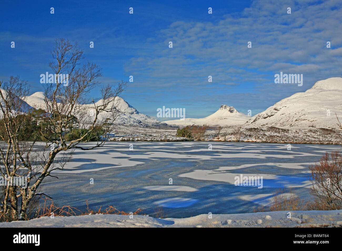 UK Scotland Wester Ross-shire Frozen Loch Drumrunie and mountains of Stackpolly and Culbeag Stock Photo
