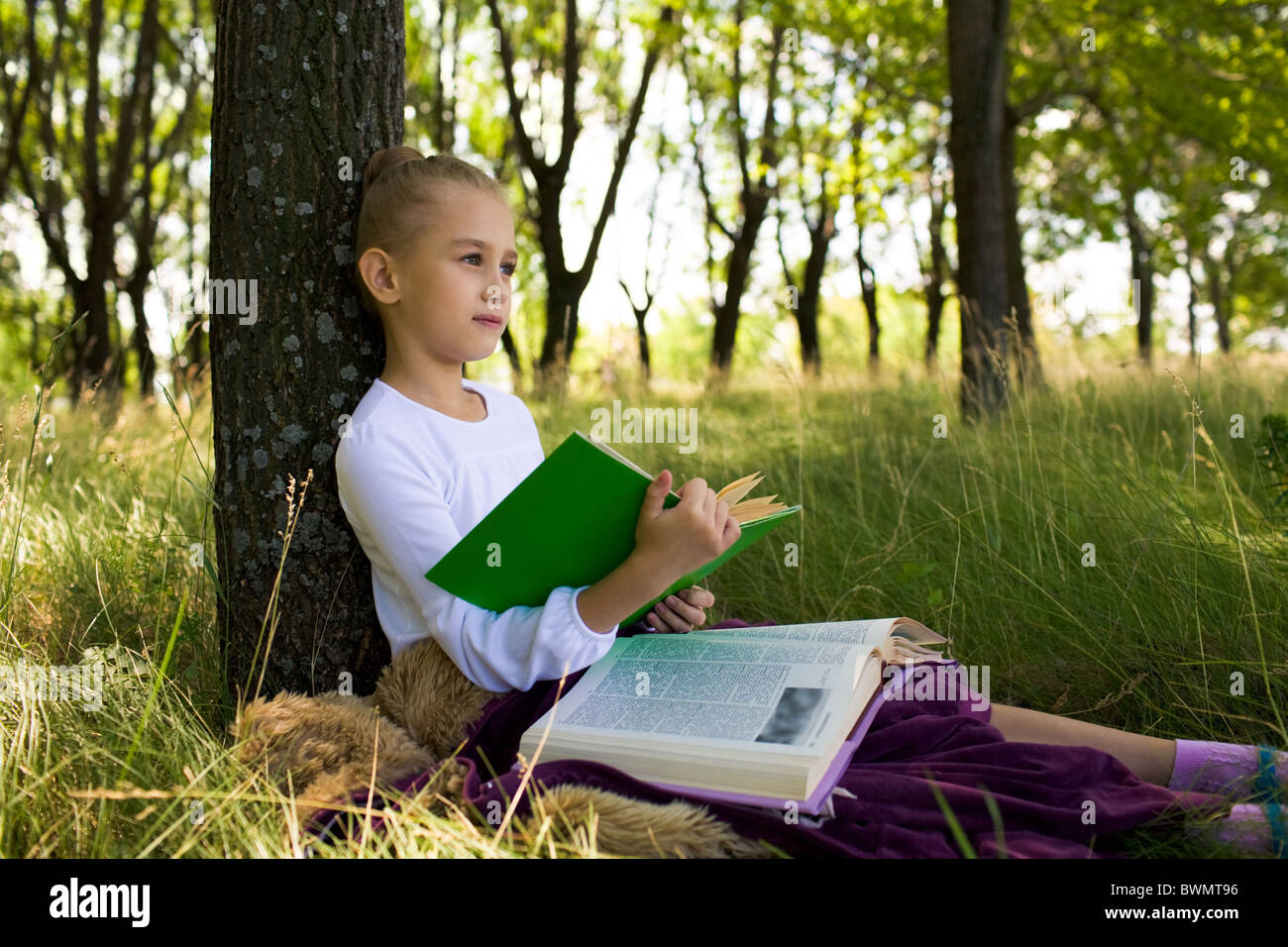 Pretty Girl Sitting Under Tree And Thinking About Something While 