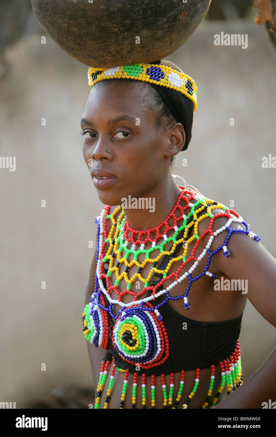 Zulu Girls Wearing Traditional Beaded Dress And Carrying Pots On Their Zulu Girls Wearing Traditional Beaded Dress And Carrying Pots On Their
