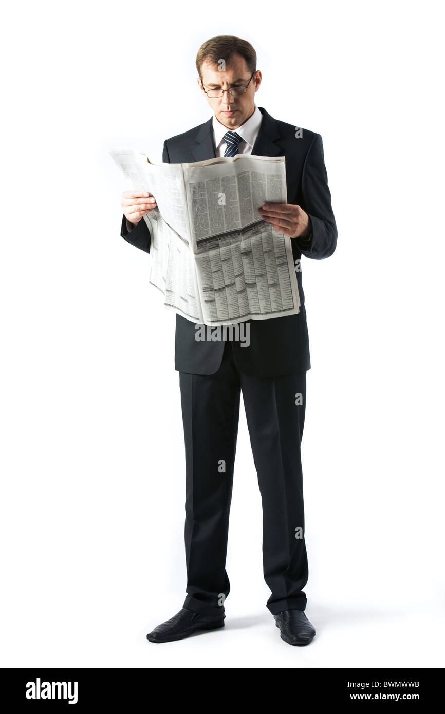 Vertical image of successful boss reading newspaper in studio Stock