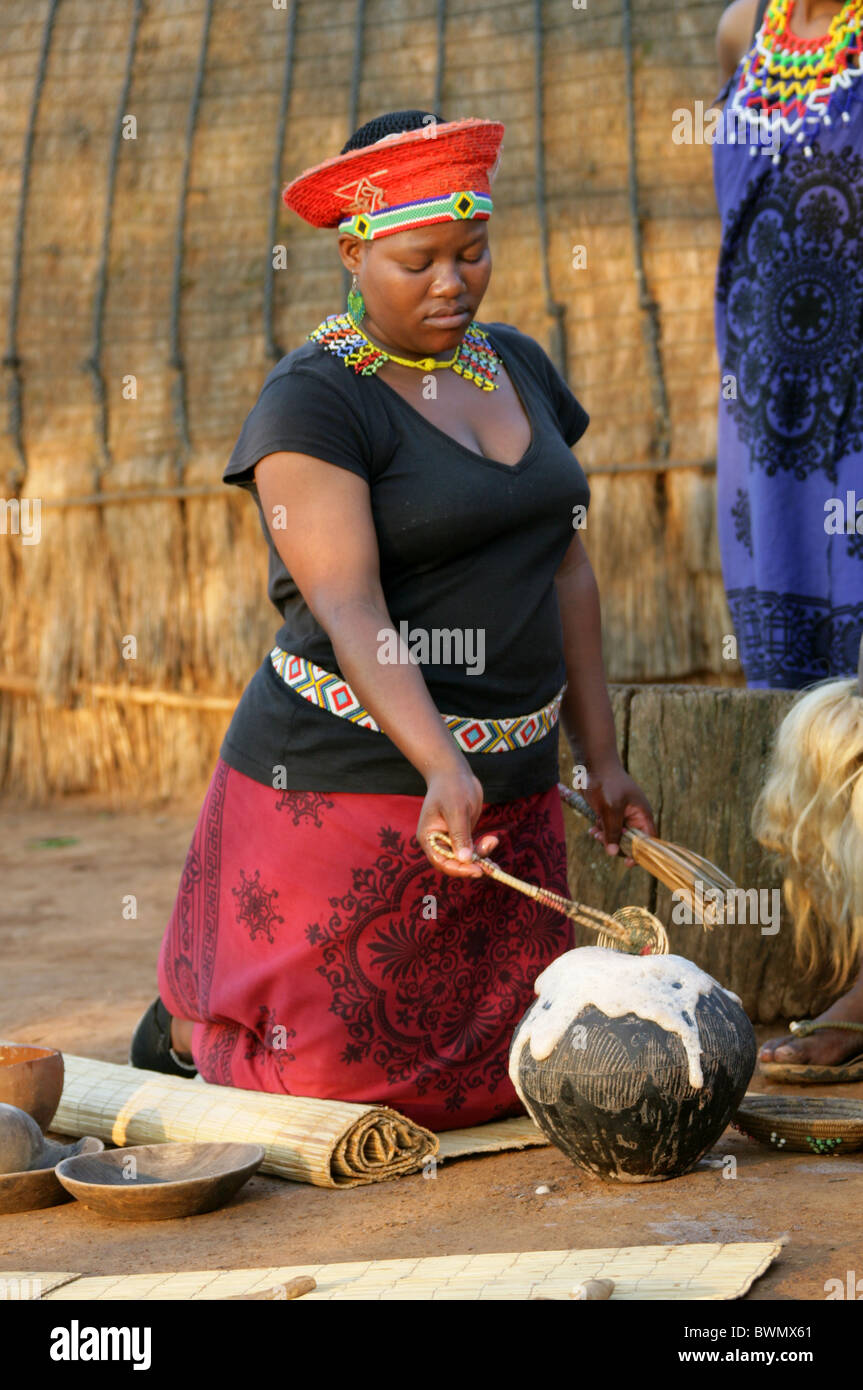 The Zulu Chief's Wife Preparing Beer for Tourist Guests, Shakaland Zulu Village, Nkwalini Valley, Kwazulu Natal, South Africa. Stock Photo