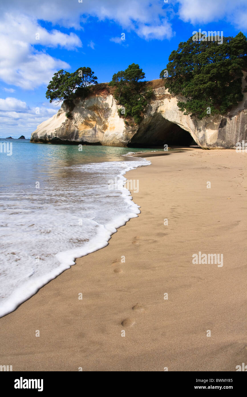 Cathedral Cove Coromandel Arch Footprints on beach in New Zealand Stock Photo