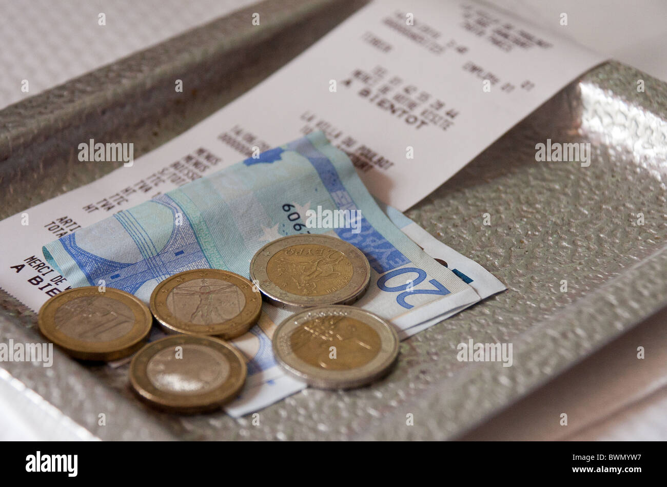 Restaurant bill with payment in Euros Stock Photo