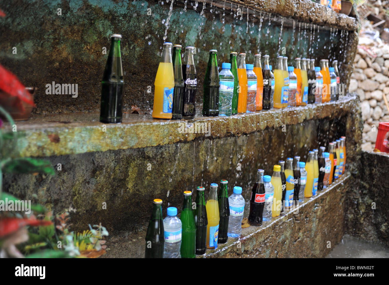 Soft drinks being kept cool by running water from the AtlasMountains in Morocco for tourists to buy nicknamed the berber fridge Stock Photo