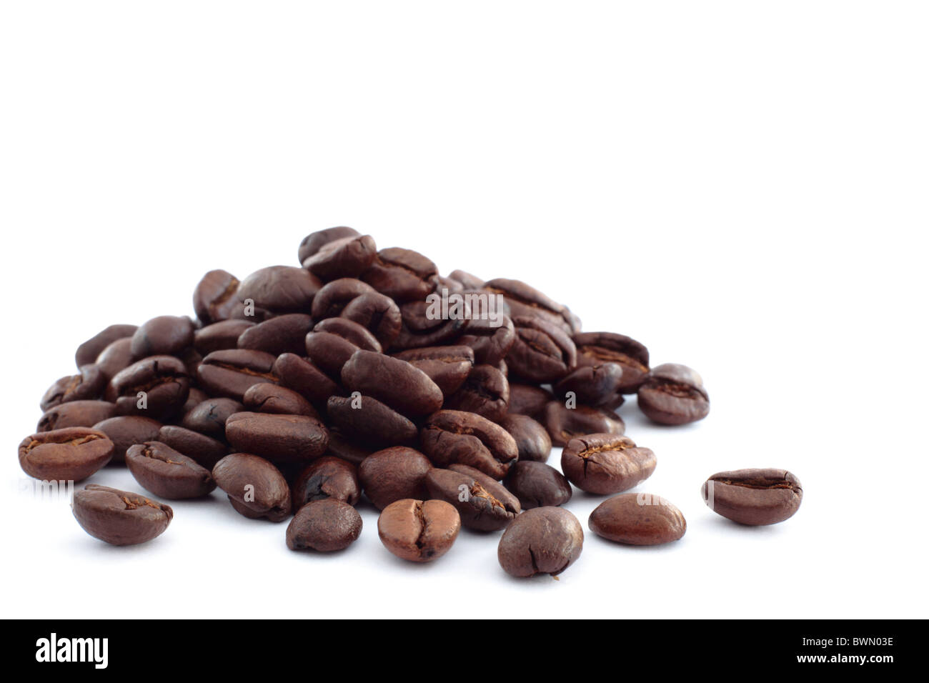 A pile of coffee beans on a white background Stock Photo - Alamy