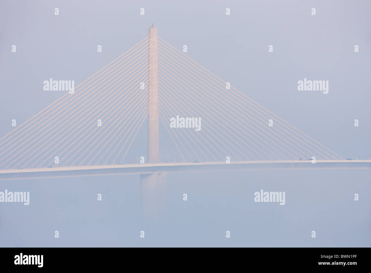 The Sunshine Skyway Bridge, spanning Tampa Bay, partially hidden by fog. Stock Photo