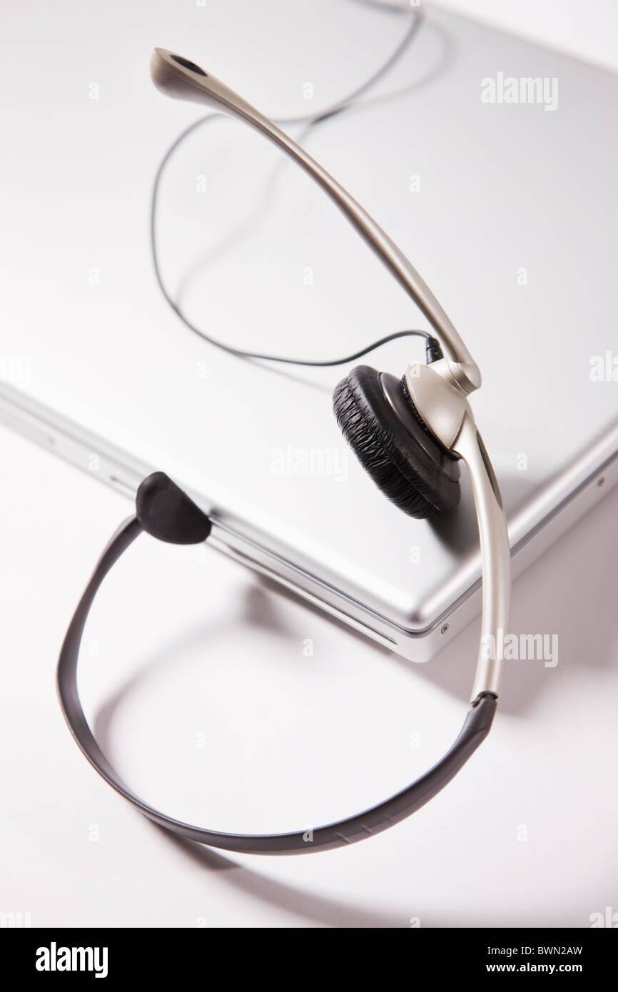 Headset on laptop on white background Stock Photo