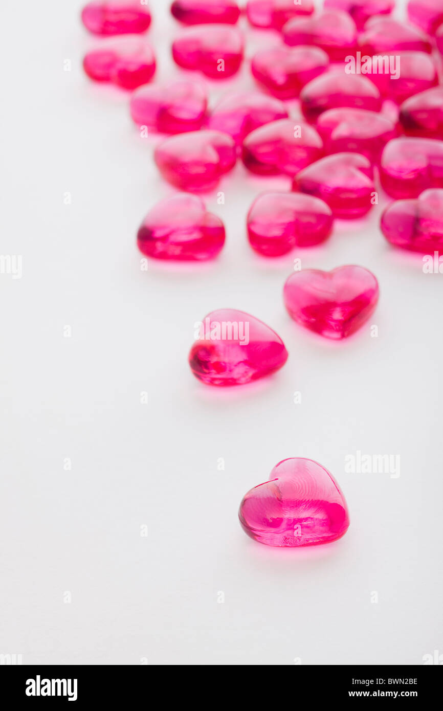 Pink glass hearts on white background Stock Photo - Alamy