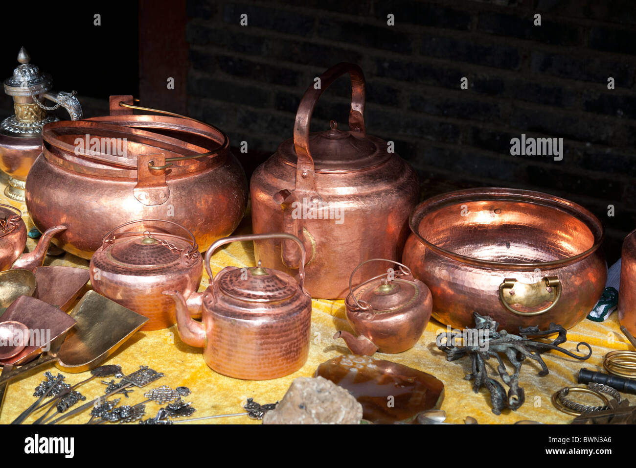 Copper souvenirs for sale in a market, Baisha village, near Lijiang, Yunnan Province, China Stock Photo