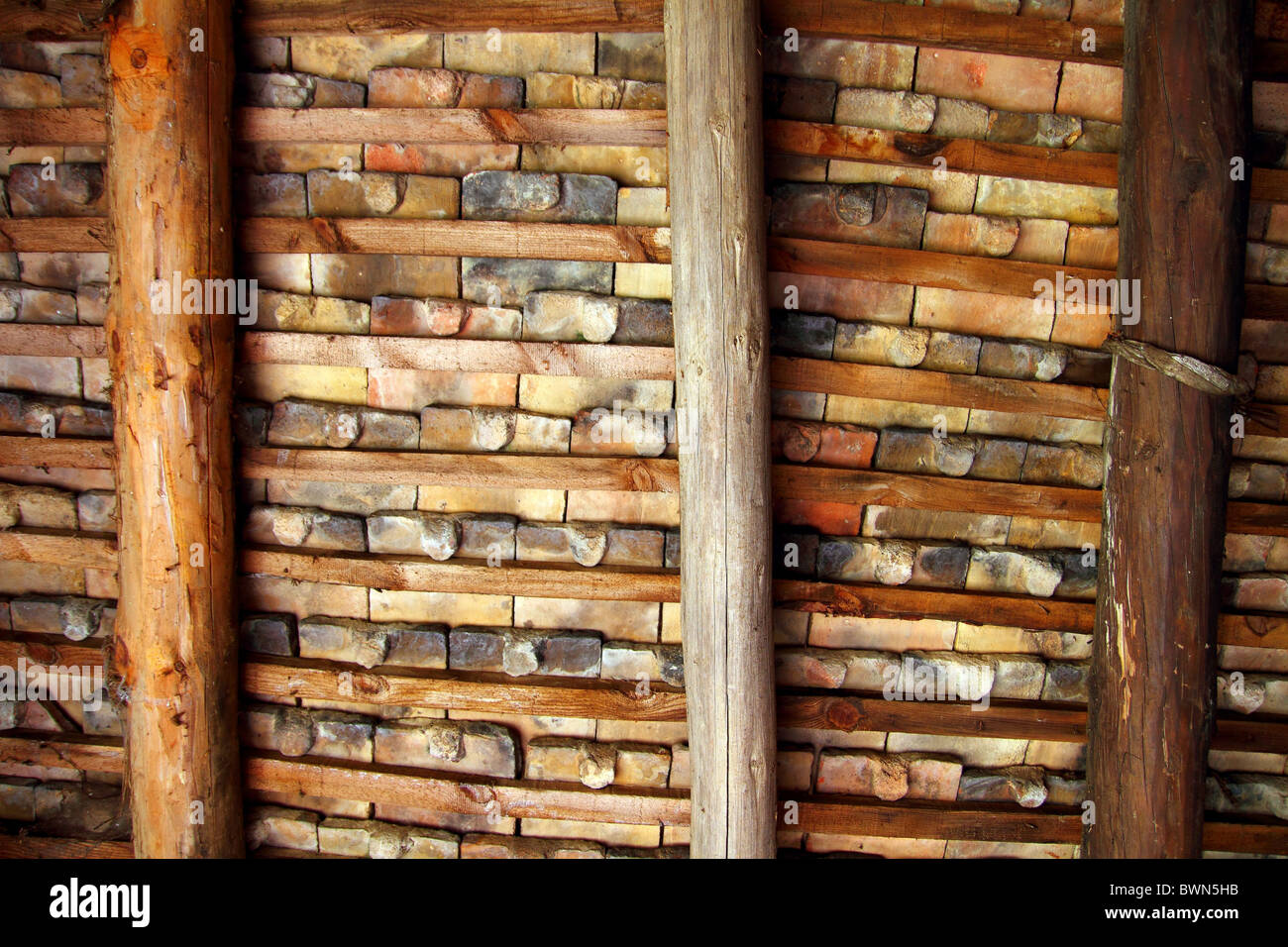 Clay square roof tiles ceiling indoor wooden beams view in Pyrenees Stock Photo