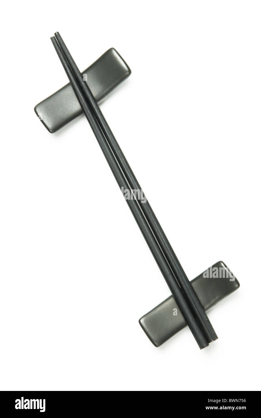 Two black wodden chopstick on holder over white Stock Photo