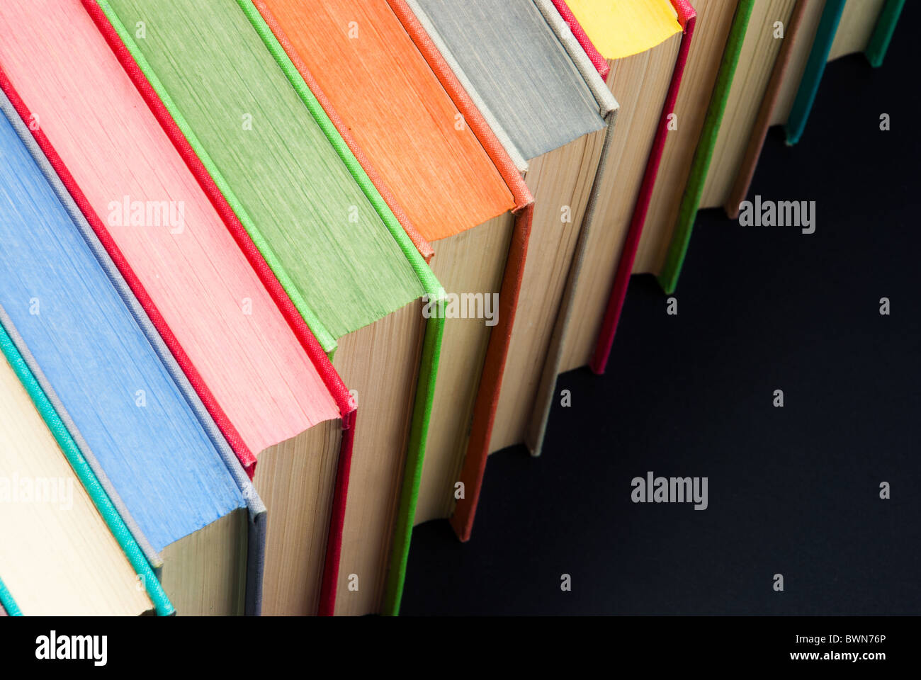 Lot of colored hard covered used books Stock Photo - Alamy