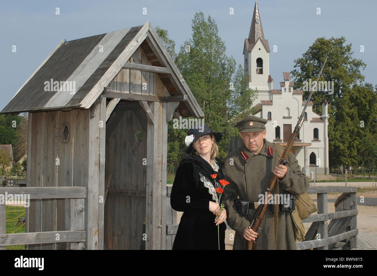 Old style picture with woman in black dress and man in soldier uniform ...