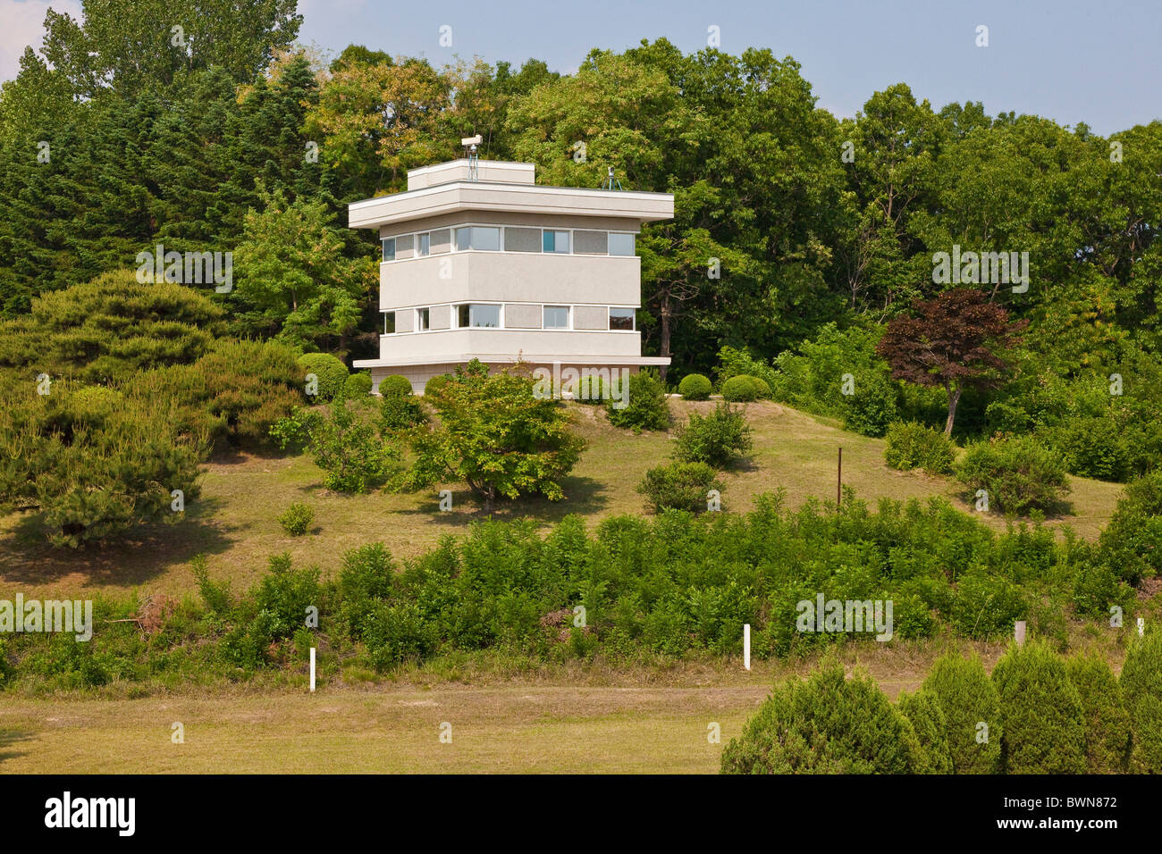 North Korean building in JSA Joint Security Area, DMZ Demilitarized Zone, with white posts indicating actual border. JMH3835 Stock Photo