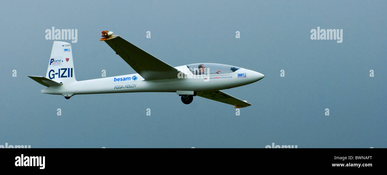 Besam Glider flying through blue sky Stock Photo