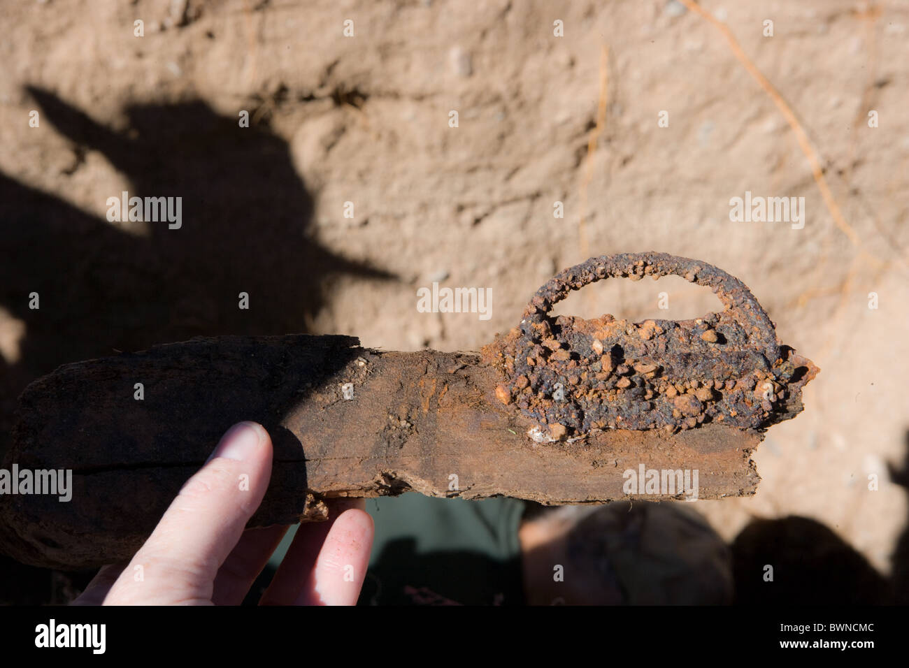 rust covered handle of a coffin, dug up from a grave, cemetery. Stock Photo