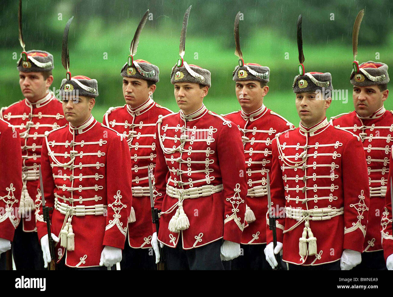 CEREMONIAL GUARD OF HONOUR, DRESSED IN RED JACKETS AND FUR HATS TRIMMED WITH A FEATHER, BULGARIA Stock Photo