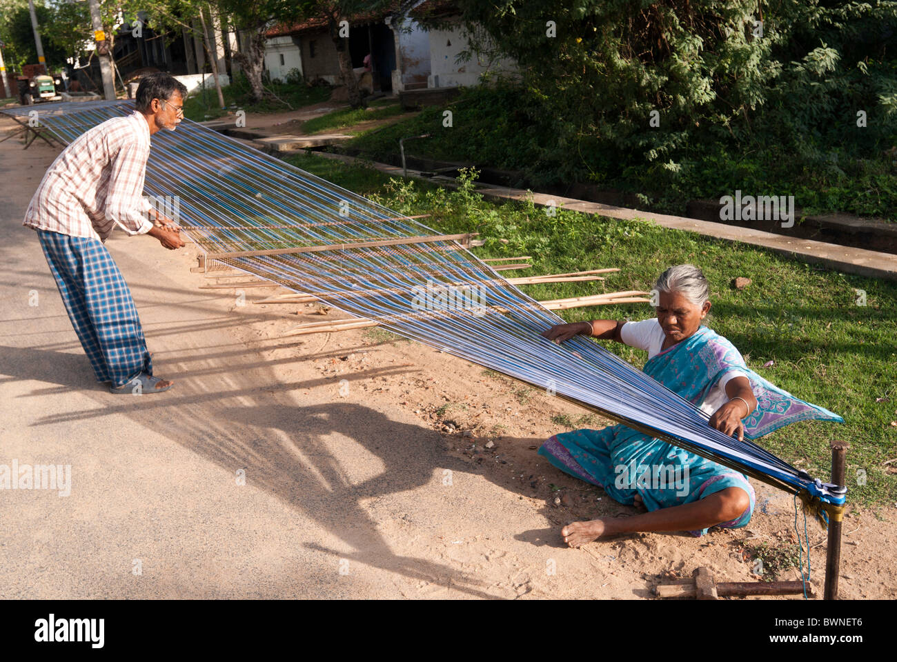 Removing knots and drying silk yarn ;old tradition practiced by weavers in Kanchipuram; kancheepuram ,Tamil Nadu,India Stock Photo