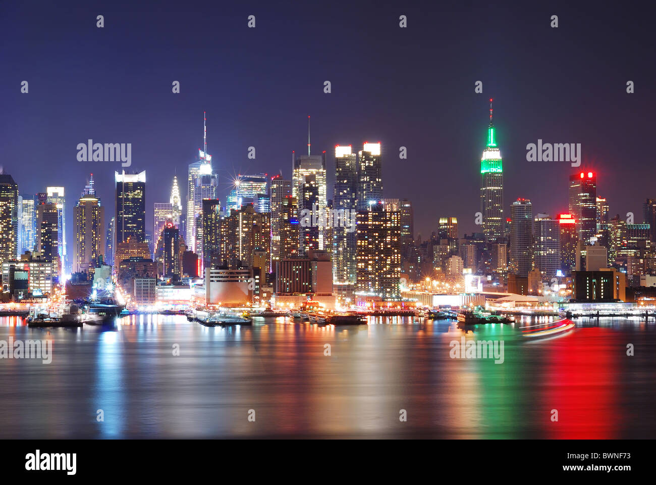 Empire State Building in New York City with Manhattan Skyline at night ...
