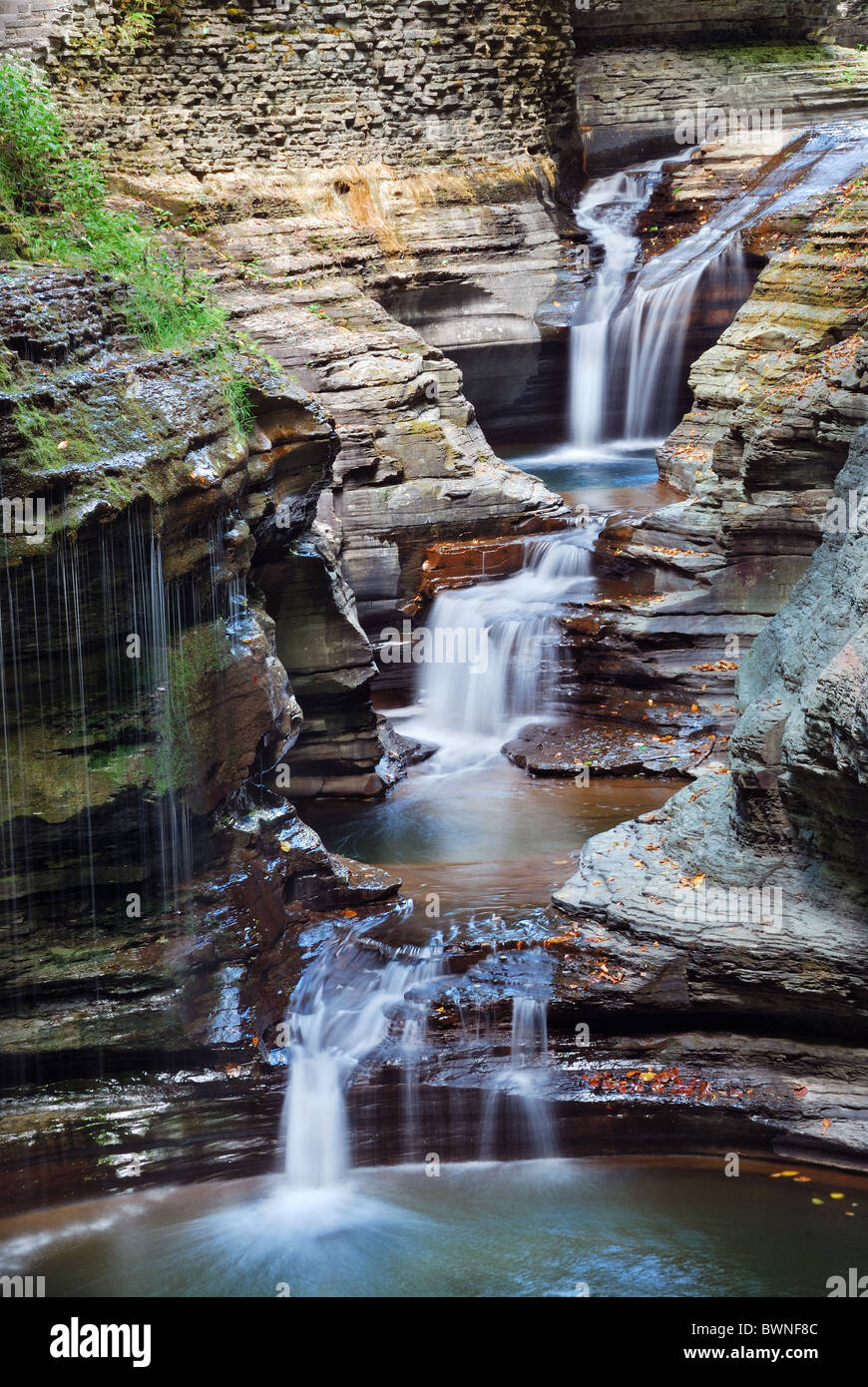 waterfall closeup in woods with rocks and stream in Watkins Glen state park in New York State Stock Photo
