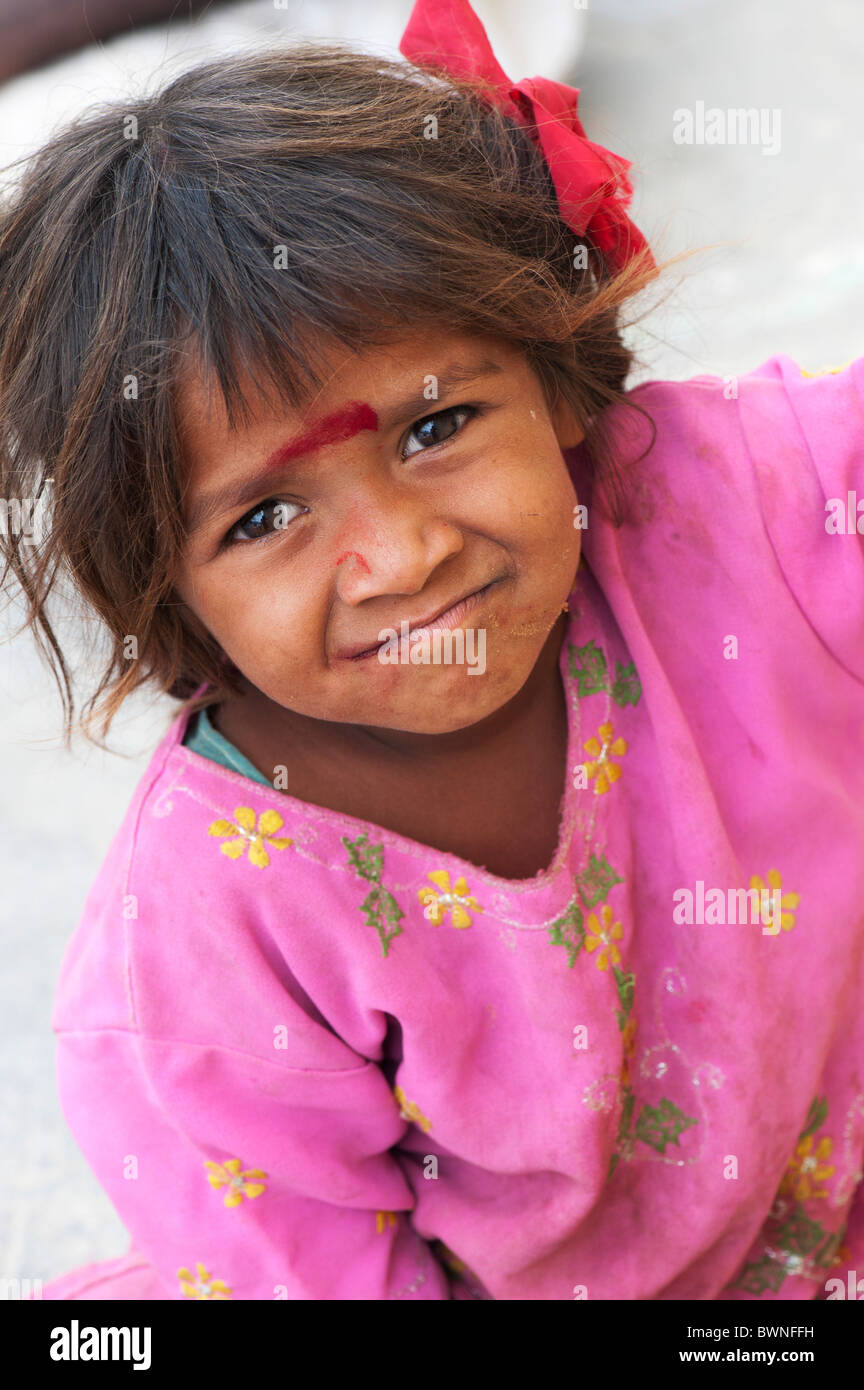 Happy young poor Indian street girl smiling looking up. Andhra Pradesh, India. Selective focus Stock Photo