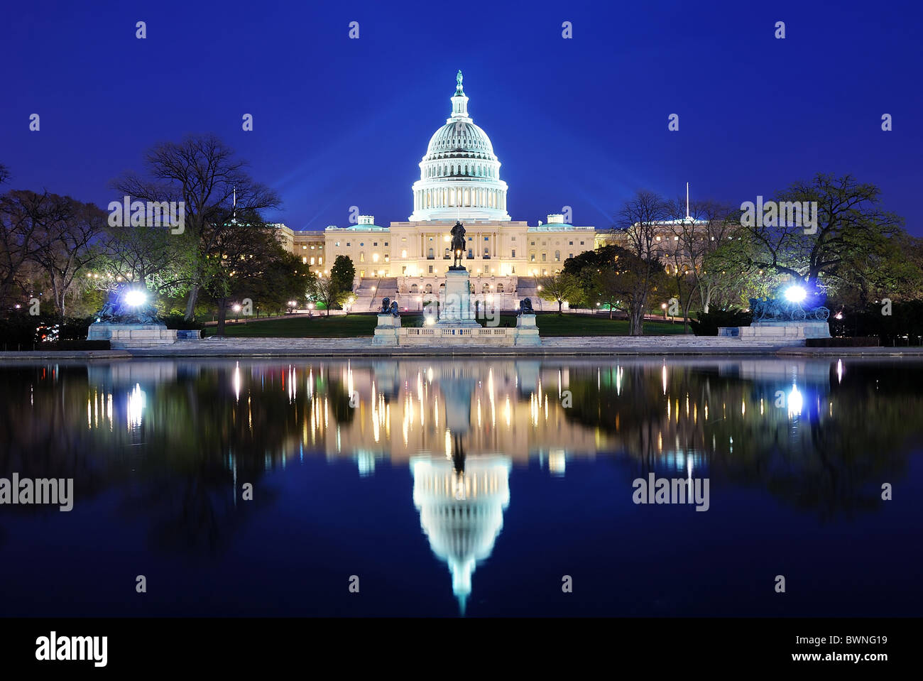 Capitol Hill Building at dusk with lake reflection and blue sky, Washington DC. Stock Photo