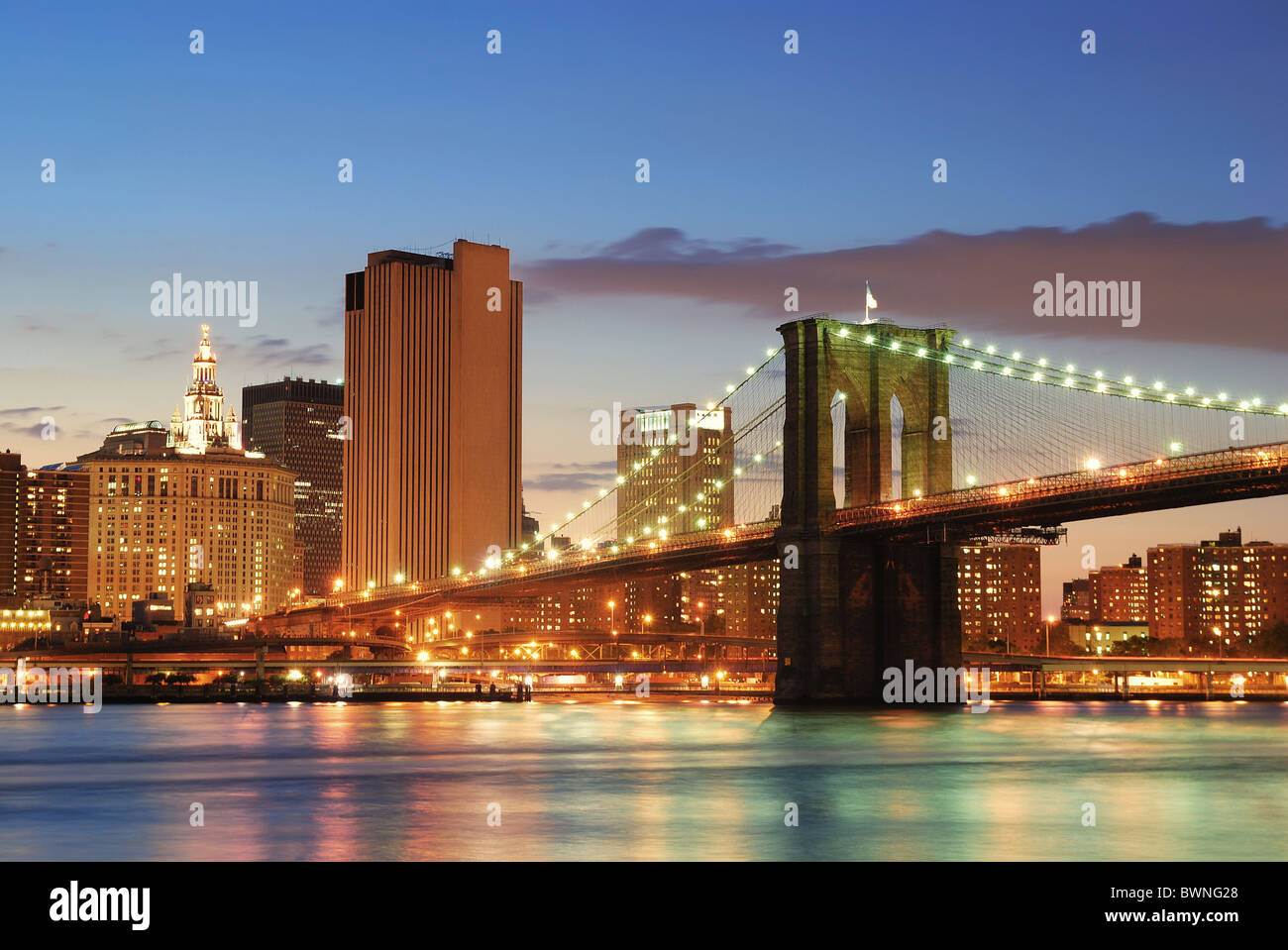 New York City Manhattan skyline and Brooklyn Bridge at dusk over Hudson ...