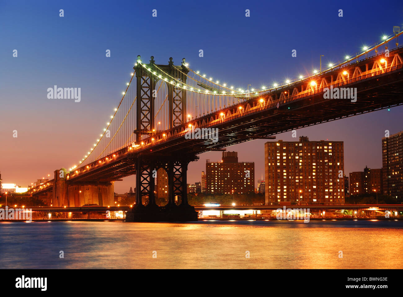 New York City Manhattan Bridge over Hudson River with skyline after sunset  night view illuminated with lights viewed from Brooklyn Stock Photo - Alamy