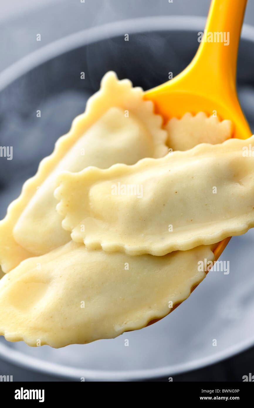Cooked ravioli lifted from pot on spoon Stock Photo