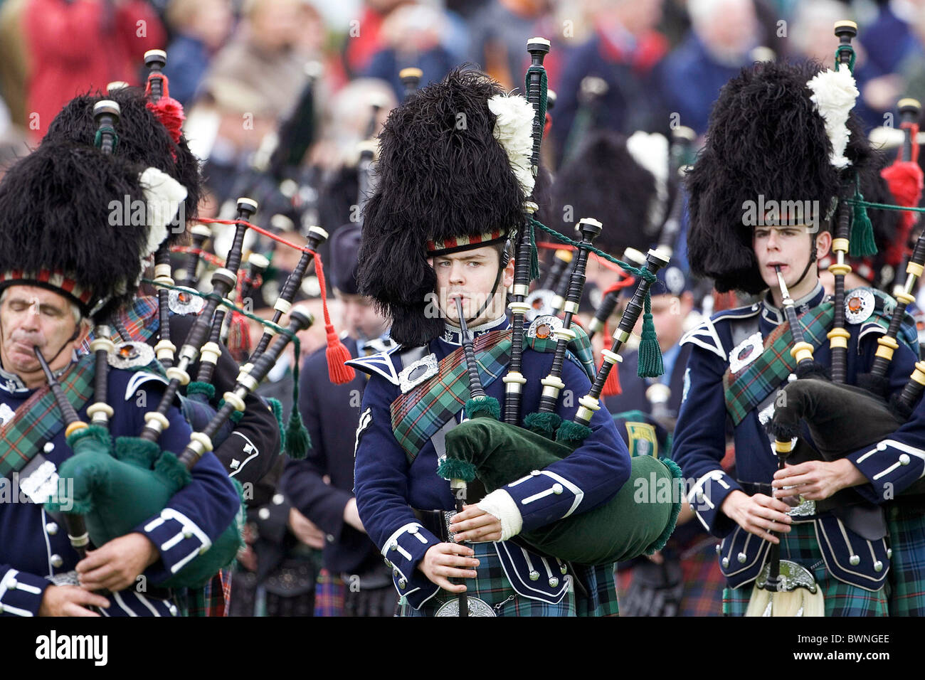 Marching pipe band with bagpipes at the Braemar Games Highland gathering annual event in SCOTLAND Stock Photo